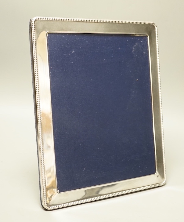 A modern silver photo frame, 25 cms wide x 30 cms high.